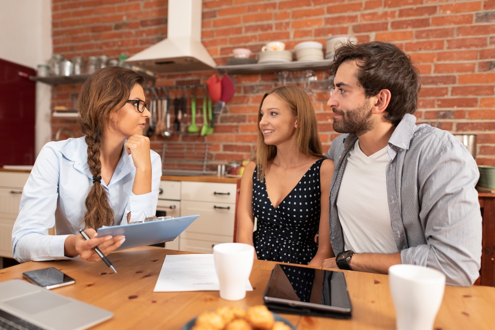 Picture of a couple discussing with a woman