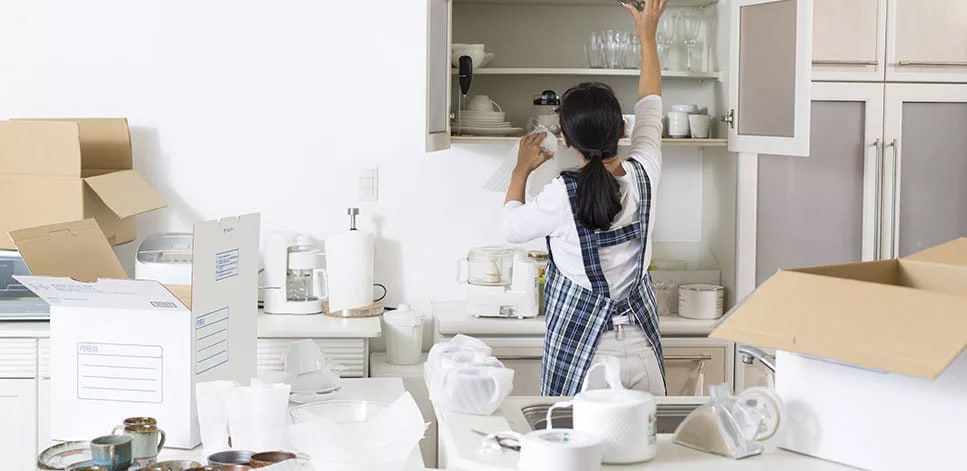 Picture of a woman unpacking kitchen things