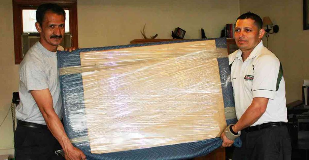 Picture of two men holding cardboard box